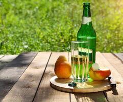 Pear cider and pears on the summer picnic photo