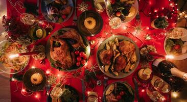 Top view no people shot of holiday Christmas table with variety of food and cozy atmosphere of New Year Eve photo