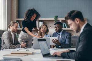 Confident business team discussing strategy while having group meeting in the office together photo