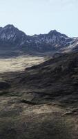 An aerial view of a mountain range with snow on the mountains video