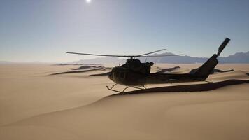 A helicopter flying over a desert landscape with mountains in the background video