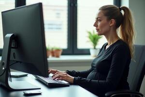 photo of pregnant woman working sitting at her desk in her office,