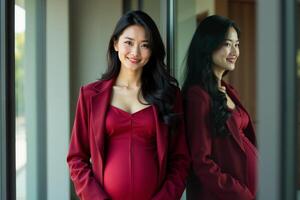 photo of happy pregnant woman standing and posing for picture with mirror and glass wall in background,