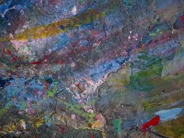 Smeared paint on table with colorful pattern for background photo
