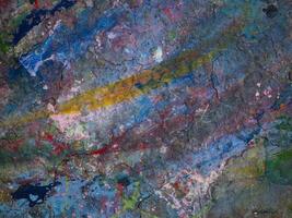 Smeared paint on table with colorful pattern for background photo