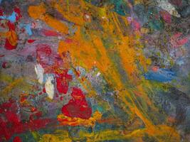 Smeared paint on table with colorful pattern for background photo