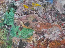 Smeared paint on table with colorful pattern for background photo