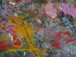 Smeared paint on table with colorful pattern for background photo