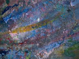 Smeared paint on table with colorful pattern for background photo