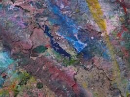 Smeared paint on table with colorful pattern for background photo