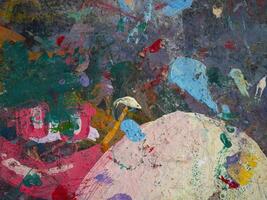 Smeared paint on table with colorful pattern for background photo