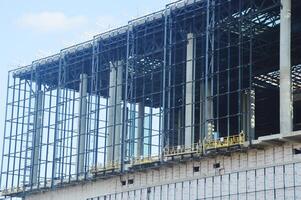 A fragment of a building under construction - roofs, ceilings, walls, rough window openings, reinforced mesh. photo