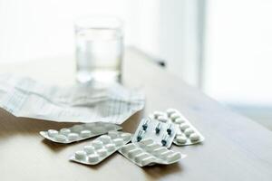 image of pills, medical prescription and medical thermometer on the table against the background of the window. Ideal for topics related to medicine, home treatment, disease epidemics photo