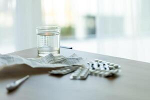image of pills, medical prescription and medical thermometer on the table against the background of the window. Ideal for topics related to medicine, home treatment, disease epidemics photo