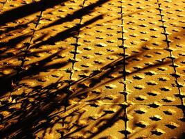 Abstract background of a brick sidewalk with a shadow cast on it. Morning sunlight on the pathway. Beauty sunlight on the ground photo