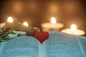 Heart space on top of a Bible with customizable space for text or religion message. Christianity and Religious concept photo