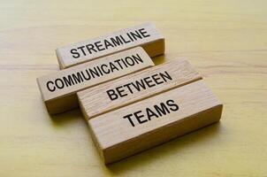 Streamline communication between teams text on wooden blocks. Operational Excellence and team work concept photo