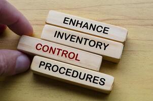 Enhance Inventory Control Procedures text on wooden blocks. Operational Excellence concept. photo