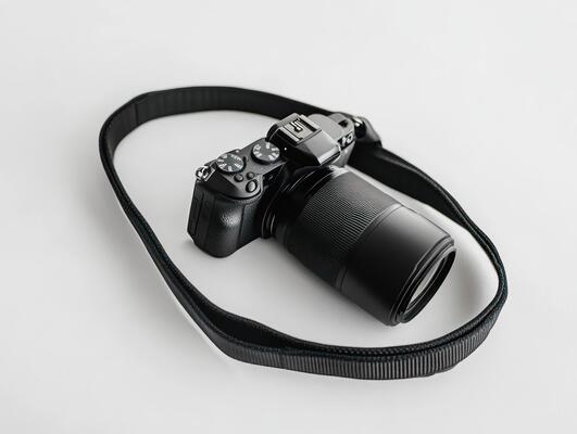 a camera strap with a black camera attached to it
