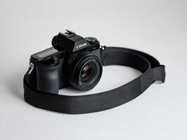 a camera strap with a black camera attached to it photo
