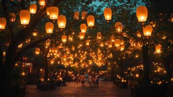 Brightly lit Chinese lanterns hanging from trees in a night garden. Mid-Autumn festival decorations photo