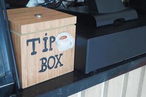 close up of a tips box in a cafe photo