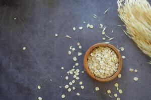 roasted oats flakes spilling on table photo