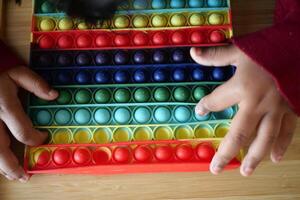 A colorful Pop It Fidget Toy designed for stress relief and sensory play enjoyment photo