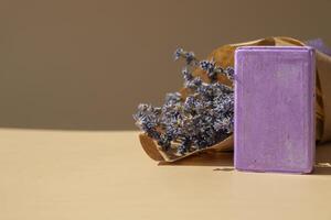 Lavender soap on beige background with copy space for your text. Advertisement template mock up. Skincare homemade natural cosmetic concept. Organic dry lavender flower. Handmade soap photo