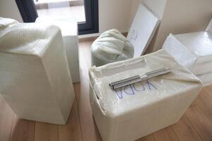 Unpacking Moving Boxes and Furniture in a New Home After a Recent Relocation Experience photo
