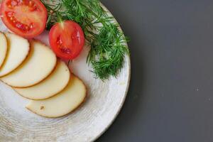 A Rustic Plate Featuring Fresh Tomato Slices and Deliciously Creamy Cheese Slices photo