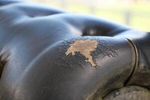 damage Leather with a cracked texture on a sofa . photo