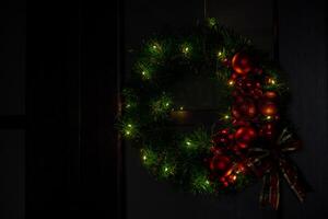 Step by step instruction of making handmade Christmas wreath made of festive decorations in red color. Female hands creating craft homemade decor. New year celebration. Winter holidays Step 4 photo