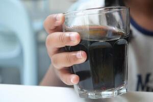child drinking glass of soft drinks photo