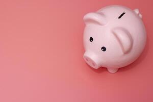 Pink piggy bank on pink background. Money and business. Money saving photo