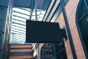 Horizontal side view of empty black signage on business skyscraper with modern architecture photo