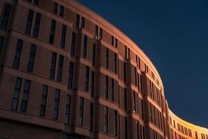The business building in the form of a wave is illuminated late at night photo