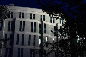 The business building in the form of a wave is illuminated late at night photo