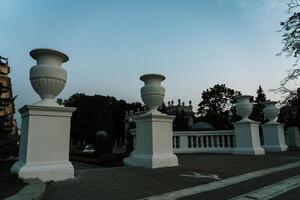 Concrete columns with capitals and bases on them. Entrance to the park photo