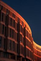 The business building in the form of a wave is illuminated late at night photo