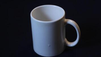 image of a white glass on a black background photo