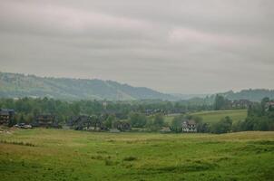 view of mountains and valleys in cloudy weather in early autumn . High quality photo