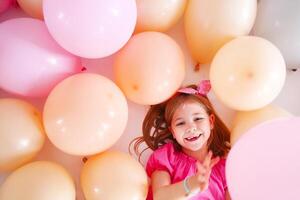 Portrait of the cute little girl in retro style over balloons background photo