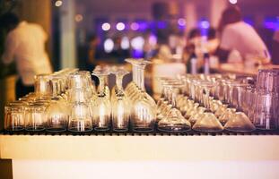 Empty glasses on bar counter photo