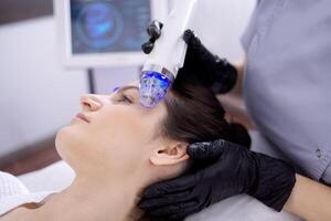 Microneedle RF lifting procedure. Hardware cosmetology. photo