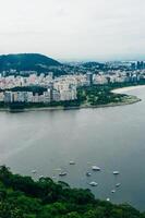 View from bottom of Sugarloaf mountain just dusk overlooking boats on Guanabara bay photo