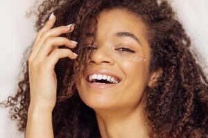 Charming african american with perfect skin and sequins on her cheeks photo
