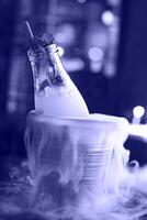 Lemonade serviced in the bottle with mint in the bucket with dry ice photo