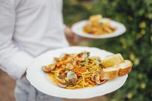 Seafood Spaghetti with seashells, prawns, squids on table background. photo