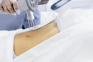Extreme close up of hand of doctor or cosmetologist in transparent glove, part of apparatus photo